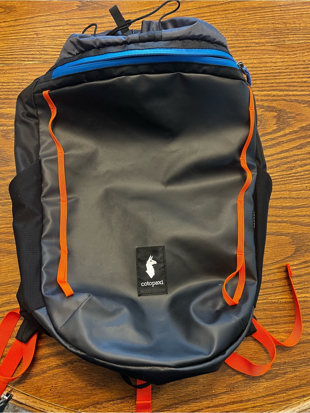 cotopaxi Black Backpack with Orange Accents and Blue Zipper